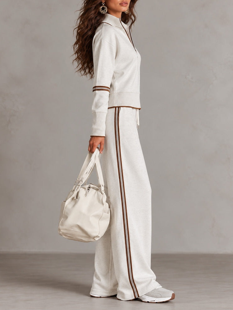 Conjunto blanco de sudadera de canalé con cuello alto y media cremallera y pantalones de pierna ancha con bloques de color