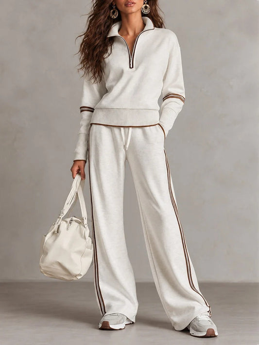 Conjunto blanco de sudadera de canalé con cuello alto y media cremallera y pantalones de pierna ancha con bloques de color