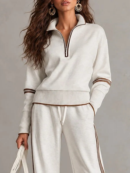 Conjunto blanco de sudadera de canalé con cuello alto y media cremallera y pantalones de pierna ancha con bloques de color