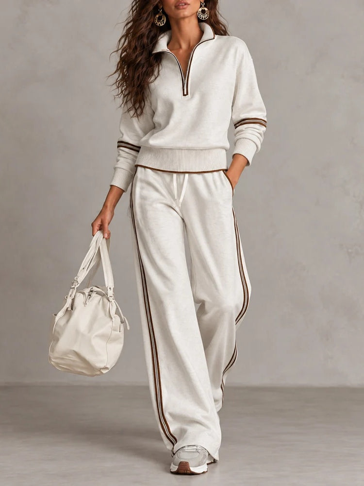 Conjunto blanco de sudadera de canalé con cuello alto y media cremallera y pantalones de pierna ancha con bloques de color